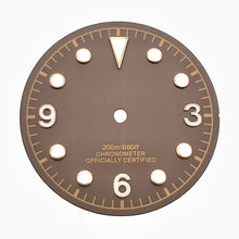Brown vintage-style diving watch dial with baton and dot markers.